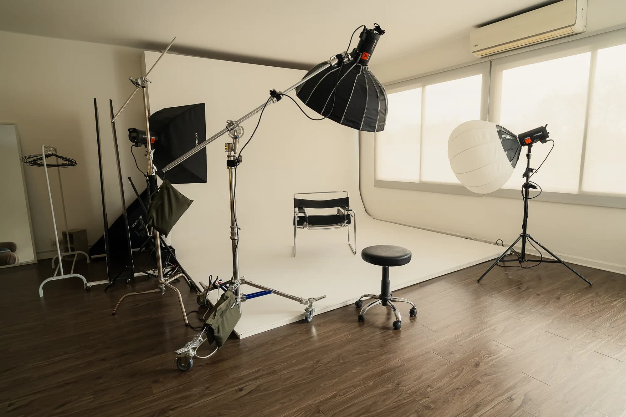 El estudio de Studio28 vacío, con el ciclorama blanco, el softbox y la silla de set