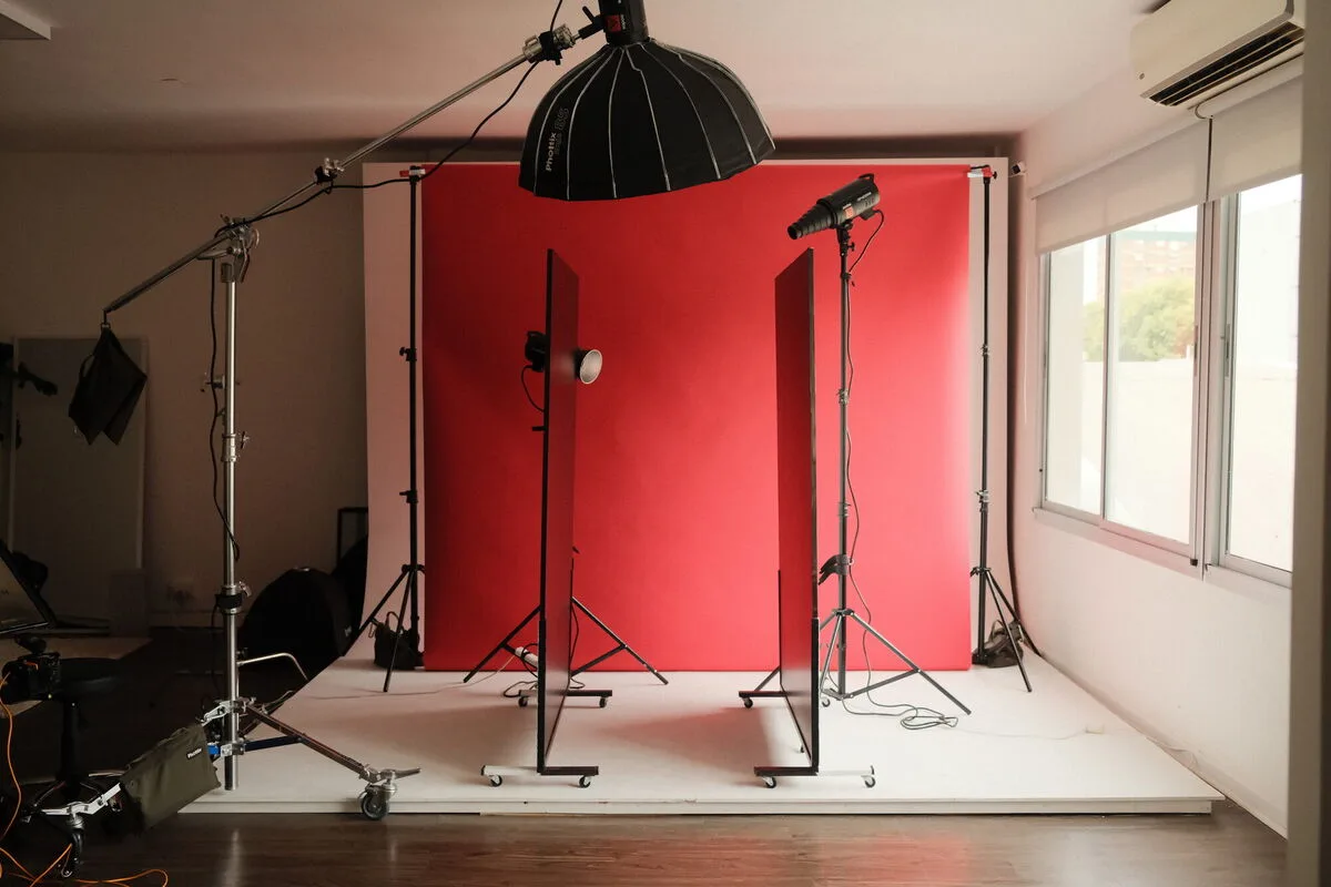 El estudio con fondo rojo, flashes y ventanales